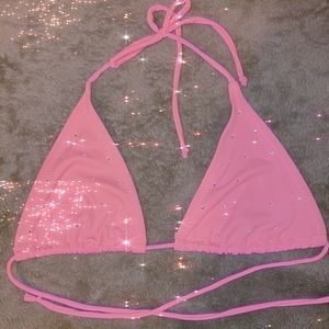 A pink with rhinestones bathing suit top